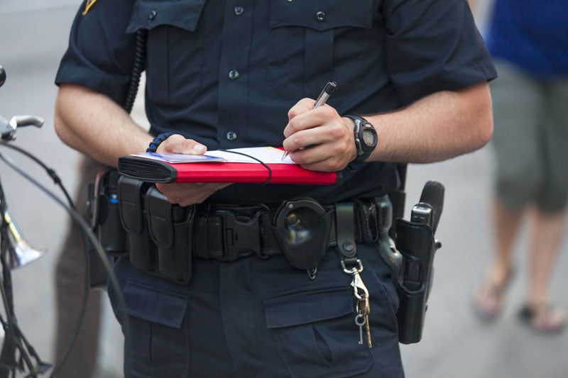 image of an officer writing a ticket