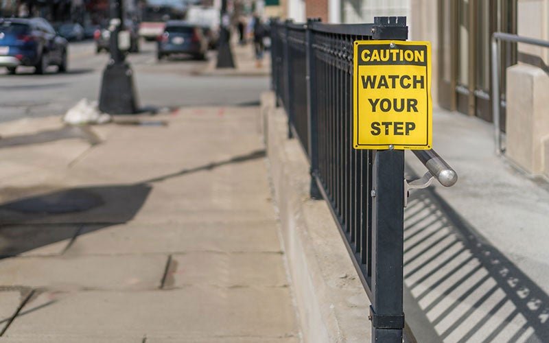 image of a watch your step sign